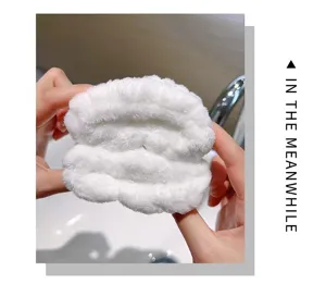 Close-up detail shot of soft fluffy absorbent wristband for washing face in bathroom setting.