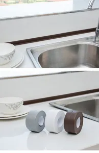 Detail view of waterproof sealing tape applied along kitchen sink edges and multi-color rolls.