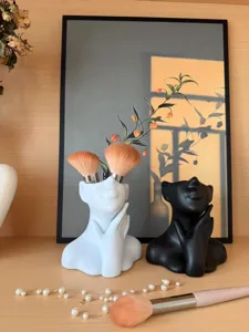 Nordic abstract human face vase detail, creative desktop pen holder and flower arrangement setup.