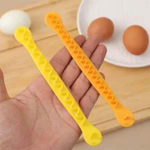 Creative egg slicer detail shot, plastic wavy design tool for kitchen salad preparation easily.