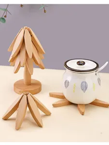 Wooden tree-shaped trivet detail showing creative foldable coaster and ceramic jar set.