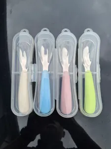 Stainless steel baby spoon detail view with portable clear case and four colorful handles.