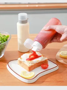 Plastic squeeze sauce bottle with scale and pointed mouth for kitchen seasoning storage use.