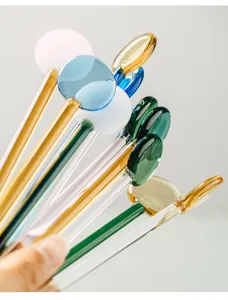 Heat-resistant glass stirring rod with colorful round head, perfect for coffee, juice and dessert.