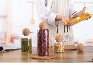Glass storage jar with round cork lid for kitchen dry food, coffee beans, and pasta organizer.