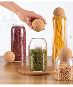 Glass storage jar with spherical cork lid for grains and coffee beans detail view.