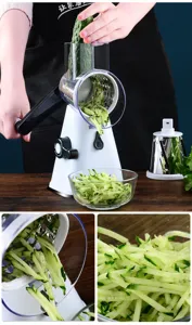 Detail view of manual rotary vegetable slicer showing blade drum and cucumber shreds.