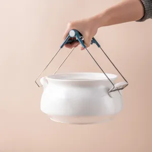 Stainless steel anti-scalding pot gripper clip for lifting hot bowls and dishes in kitchen.