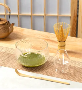 Detailed view of hammered glass matcha bowl set with bamboo chasen whisk and tea scoop.