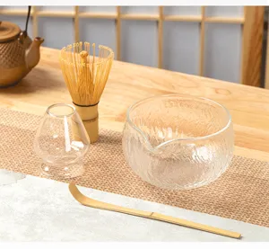 Hammered glass matcha bowl set complete with bamboo tea whisk, holder and scoop for tea.
