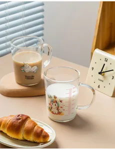 Glass measuring milk cup with cute unicorn pattern and clear scale lines for kitchen.