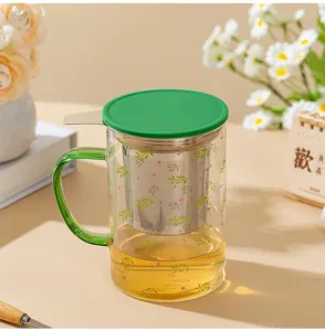 Heat-resistant glass tea mug with stainless steel infuser and green lid for office use.