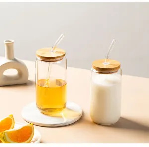 Detailed view of clear glass cups featuring natural bamboo lids and straws, stylish design.