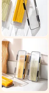 Clear plastic pasta storage container detail with secure black clips for kitchen organization.