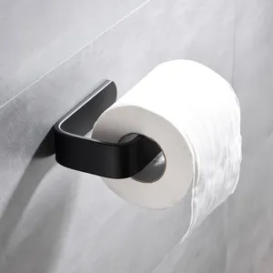 Matte black wall-mounted toilet paper holder detail, modern minimalist bathroom hardware design.