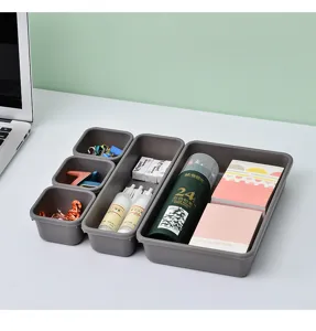 Graues Kunststoff-Desktop-Aufbewahrungsset, modulare Fächer für Büromaterial und Kleinigkeiten.