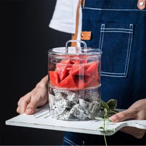 Bocal de stockage en verre transparent à double couche avec couvercle pour fruits frais.