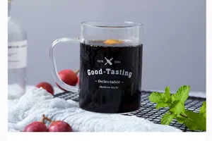 Glass mug detail shot, featuring stylish text print, ideal for coffee and drinks.