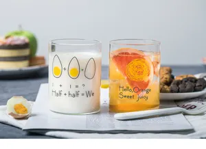 Close-up detail of creative glass cup with cute print, perfect for morning milk or juice.