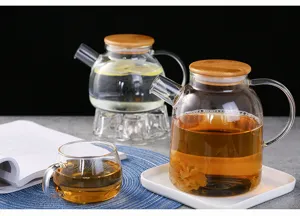 Clear borosilicate glass teapot with wooden lid, detailed view for flower tea and cold water.