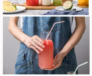 Clear glass cold water bottle juice drink container with straw for daily home kitchen use.