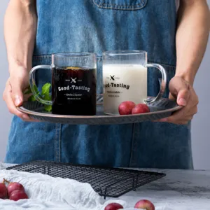 Clear heat-resistant glass mug with handle, perfect for juice, coffee, and daily cold or hot drinks.
