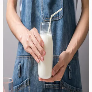 Clear glass milk bottle with straw detail, perfect for serving fresh beverages and daily drinks.