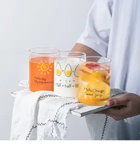 Close-up detail of creative heat-resistant glass cups with cute printed patterns, perfect for milk and juice.