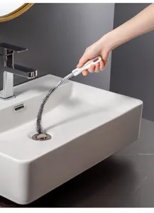 Close up view of the flexible drain cleaning brush in action inside a bathroom sink.