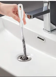 Detailed view of flexible sink drain cleaning brush with white handle for hair removal.