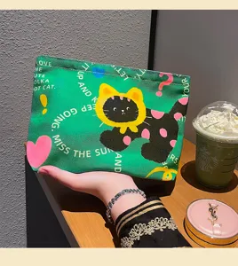 Green canvas makeup bag with cute cat print, portable zipper cosmetic storage pouch for travel.