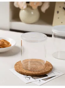 Pot de stockage en verre transparent avec couvercle étanche et sous-verre en liège.