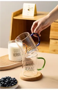 Clear glass mug with colorful handle and morning print for breakfast milk coffee home use.