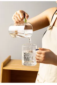 Clear glass water cup with colorful handle and printed text, ideal for breakfast, coffee or milk.