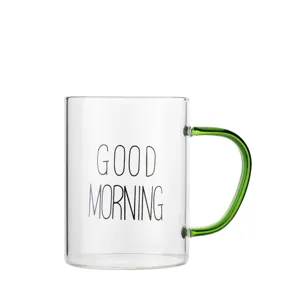 Clear glass coffee mug with green handle and good morning print for daily breakfast and milk use