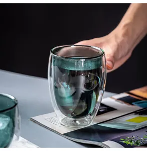 Detail shot of a double-wall insulated glass cup, clear borosilicate coffee mug for office tea.
