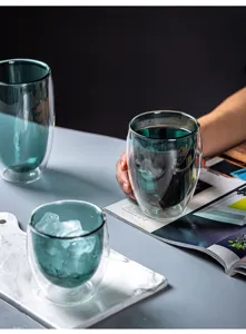 Detail view of the creative double wall glass cup showing heat insulated design and dark cyan color.