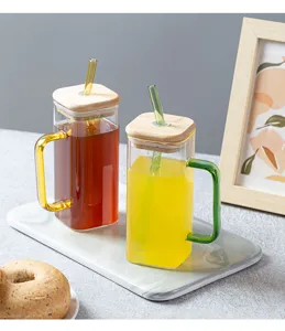 Square glass cup with bamboo lid and straw, stylish transparent drinkware for home use.