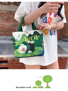 Detailed view of cute canvas tote bag with bear print, casual green and white daily handbag.