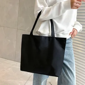 Black canvas tote bag for women, large capacity casual shoulder handbag for daily use.