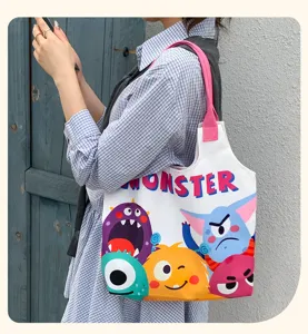Cute monster print canvas tote bag, large capacity casual shoulder bag for students.