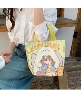 Close-up detail of the cute cartoon bear canvas tote bag showing the textured fabric and print.