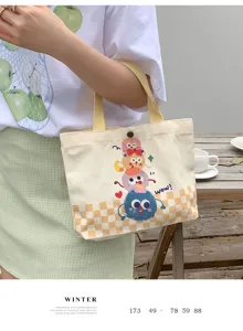 Close-up of cute cartoon monster canvas tote bag detail, featuring casual daily use style.