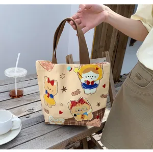Cute canvas tote bag with cartoon cat print, versatile lunch handbag for daily commute.
