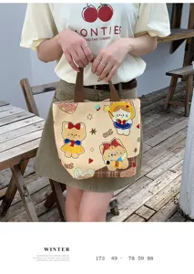 Canvas tote bag featuring cute cartoon bear and cat prints, ideal for daily commuting and lunch.