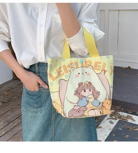 Detail view of yellow canvas tote bag showcasing a cute bear print and sturdy handles.