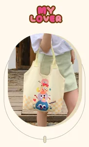 Cute cartoon canvas tote bag for women, large capacity casual shoulder bag with monster print.