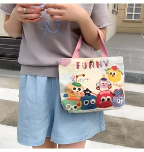 Cute cartoon monster canvas handbag for women, casual tote bag with pink handles, daily use.