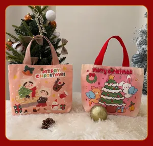 Sac cabas en toile de Noël avec motifs de dessins animés mignons et poignées en tissu.