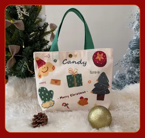 Sac cabas en toile de Noel avec des imprimés de dessins animés mignons et poignées vertes.